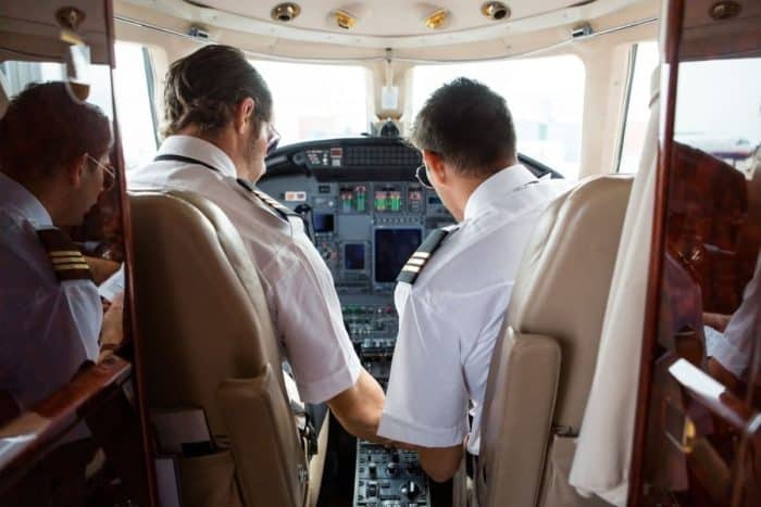 Pilot and copilot in cockpit of corporate jet