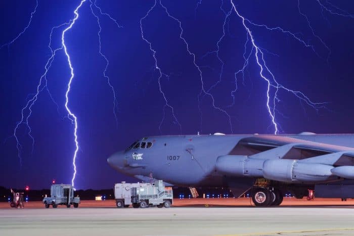 Lightning strikes behind a Boeing B-52H Stratofortress at Minot Air Force Base, N.D., Aug. 8, 2017