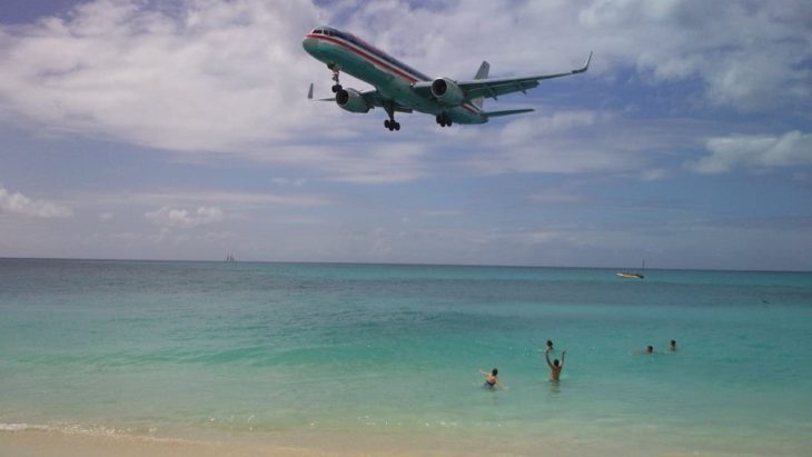 Plane flying low over beach
