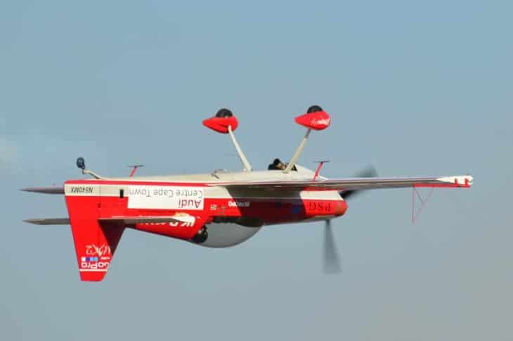 Red stunt plane inverted
