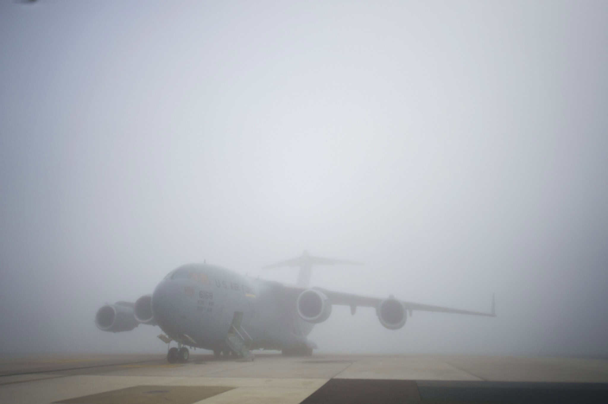 C 17 Globemaster III aircraft sits on the foggy runway