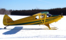A Piper PA 12 Super Cruiser on skis.
