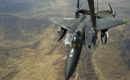 A U.S. Air Force F 15E Strike Eagle is refueled by an Air Force KC 10 Extender.