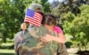 American soldier reunited with daughter waving US flag