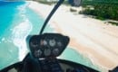Helicopter cockpit view over beach