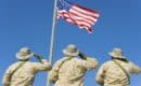 three soldiers saluting an American flag