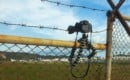 Plane spotters camera on the fence shooting airplane takeoff