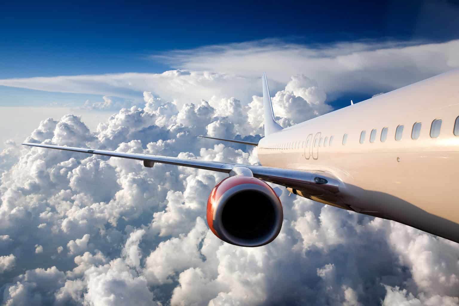 airplane flying over a dramatic sky
