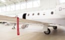 Airplane in Hangar with remove before flight Labels