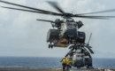 Sailors signal a Sikorsky MH 53E Sea Dragon