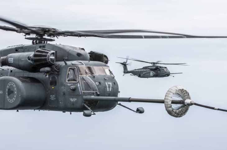 Sikorsky MH-53E Sea Dragon approaching a refueling drogue with a second helicopter behind it