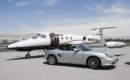 convertible and private jet on landing strip