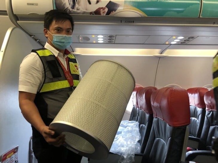 Air Asia ground crew holding High Efficiency Particulate Air HEPA filter