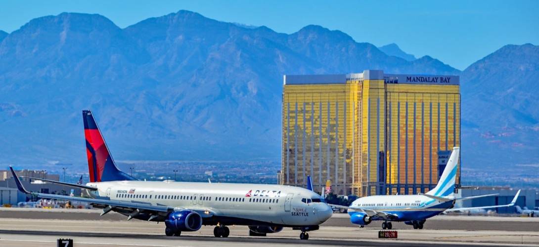 Delta Air Lines 2013 Boeing 737 932ER in the foreground and a Las Vegas Sands Corporation 2002 Boeing 737 7BCBBJ in the background