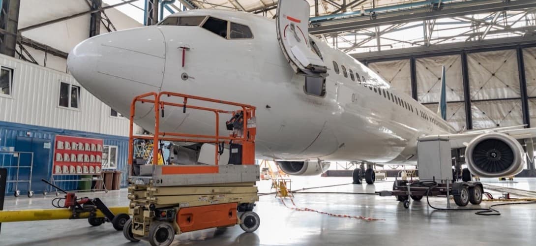 Passenger aircraft in for maintenance of engine and fuselage repair
