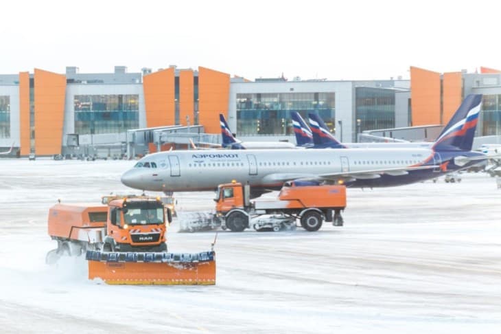 Snowplow removing snow from runways and roads in airport during snow storm in SHEREMETYEVO airport