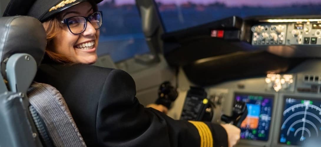 Female student pilot in flight simulator
