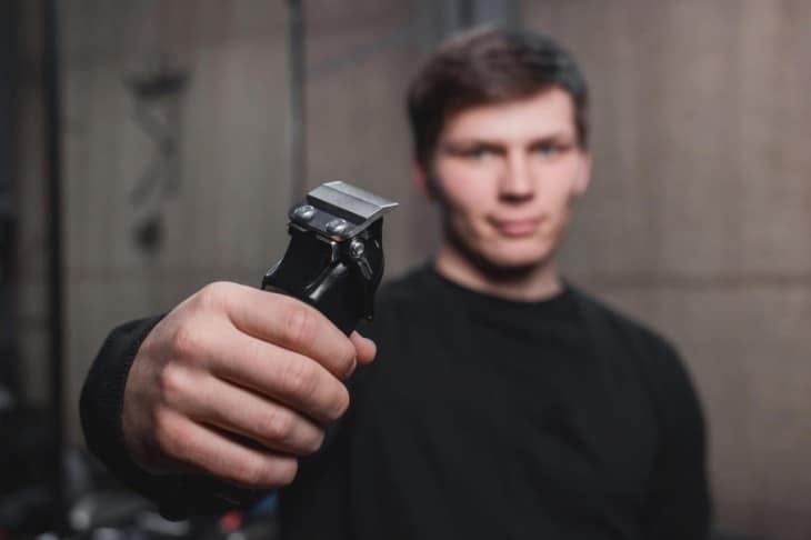 Guy holding electric clippers