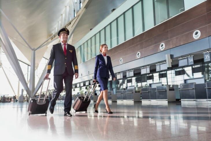 pilot and stewardess walking in airport