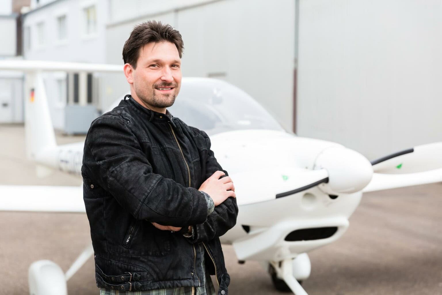 sport pilot in front of his plane