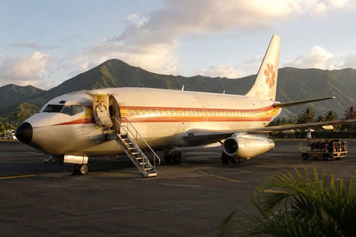 A Boeing 737-200 aircraft of the type operated by Aloha Airlines, parked on a Hawaiian airport ramp