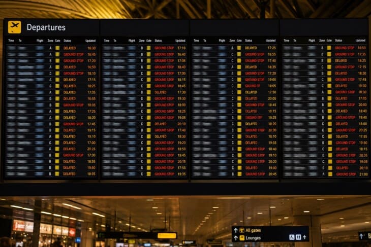 Airport departure board showing multiple delayed flights during a ground delay program