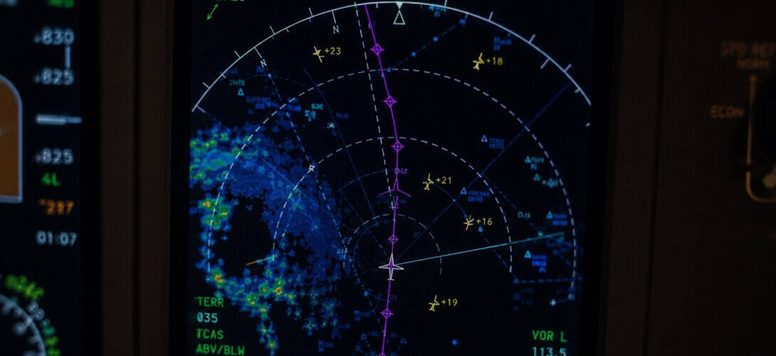Aircraft navigation display in a commercial cockpit showing route line and waypoints during cruise flight