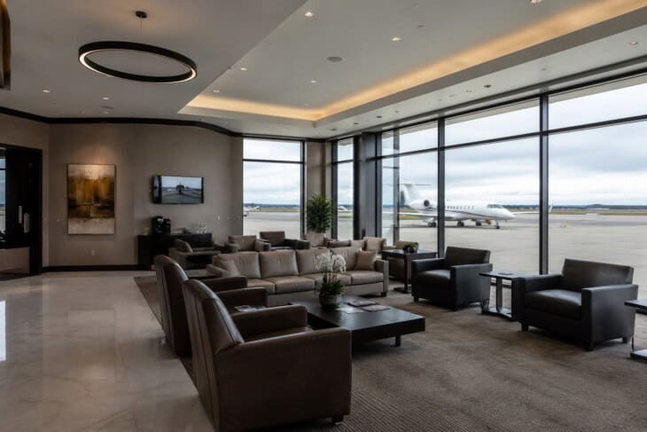 Private aviation FBO lounge with a jet visible through the window