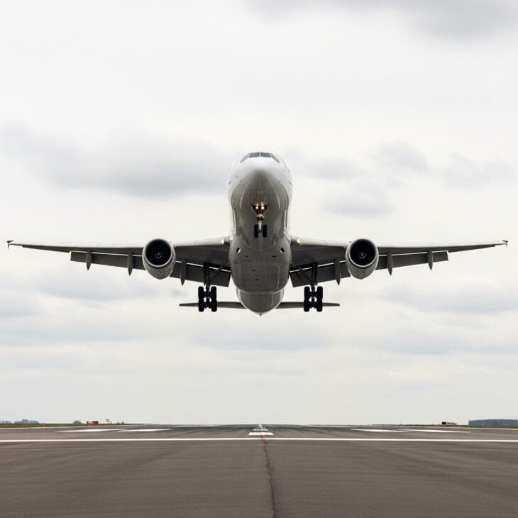Large jet aircraft at low altitude on final approach with landing gear and flaps fully extended