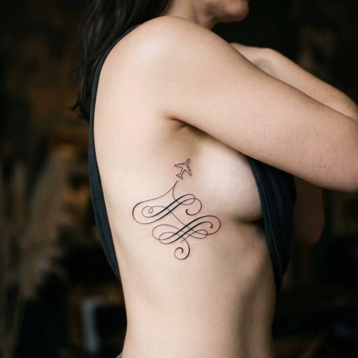 Refined script-style aviation quote fragment tattoo on an adult ribcage with a tiny airplane line above it