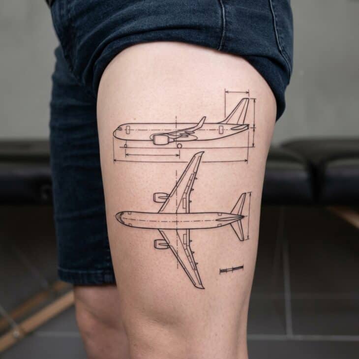 Blueprint-style generic aircraft tattoo on an adult thigh with clean technical side and top view linework