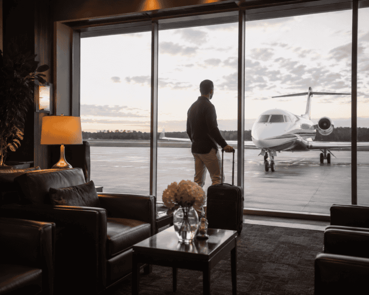 Traveller in an FBO lounge moments before boarding a last-minute private jet booking