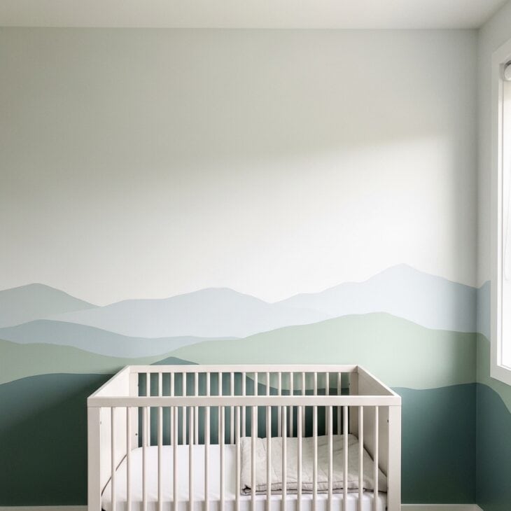 Nursery wall with a painted mountain horizon silhouette along the lower half