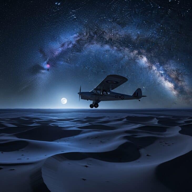 Small monoplane flying at night above a moonlit North African desert under a vast Milky Way sky