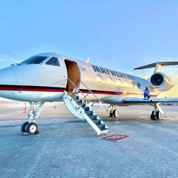Floyd Mayweather sitting on the wing of his Gulfstream IV
