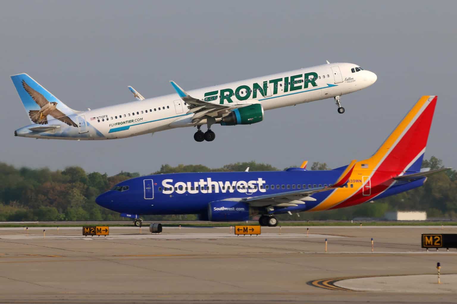 Frontier A321 lifts off 6R as a Southwest 737 taxies out