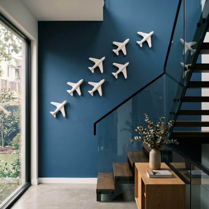 A rising formation of small relief aircraft turns blank wall space into movement.
