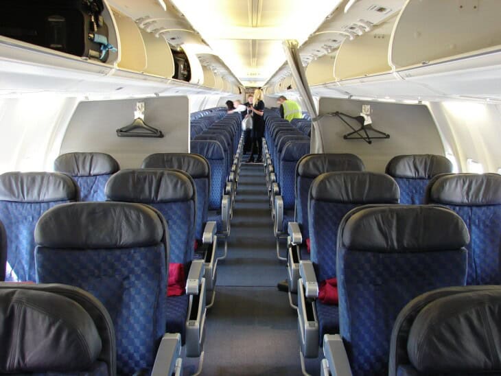 Blue economy seats three either side of a single aisle in an American Airlines Boeing 737-800 cabin