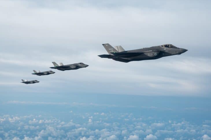 Four Royal Australian Air Force F-35A fighters flying in formation above cloud