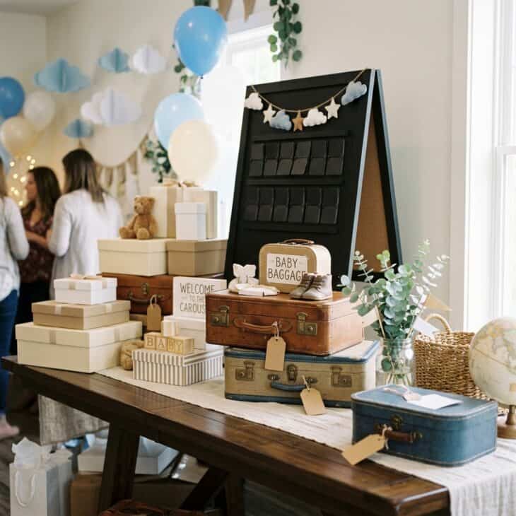 Suitcases and luggage tags turn the gift table into a playful baggage claim.