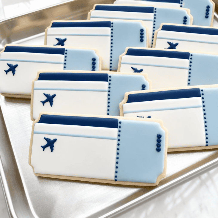 Ticket-shaped cookies offer a polished surface for simple aviation details.