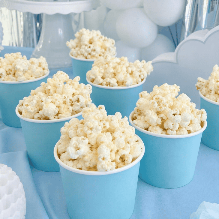 White popcorn in blue cups is an easy edible cloud effect.