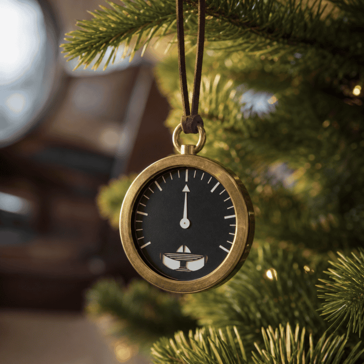 A brass-rimmed altimeter dial ornament nods to the cockpit instrument panel.