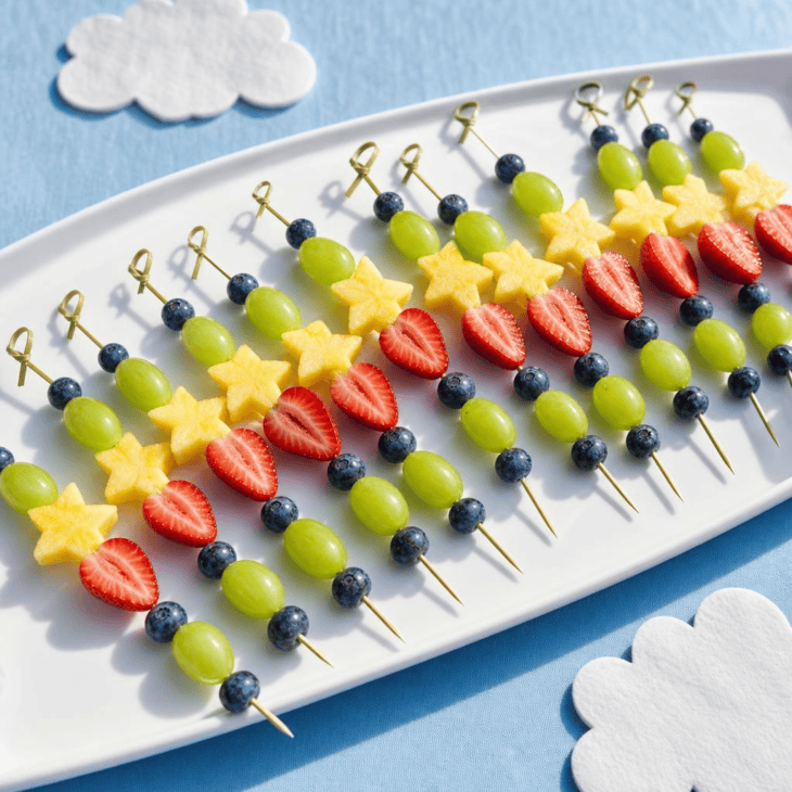 Curved rows of fruit skewers suggest colorful routes across the table.