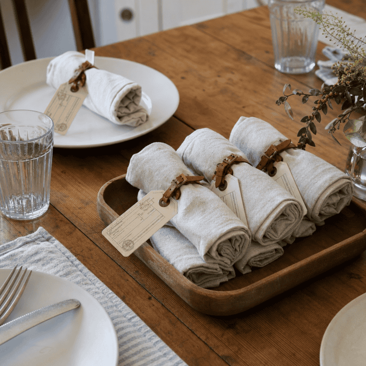 Luggage-tag napkin rings dress the table for a simple family dinner.
