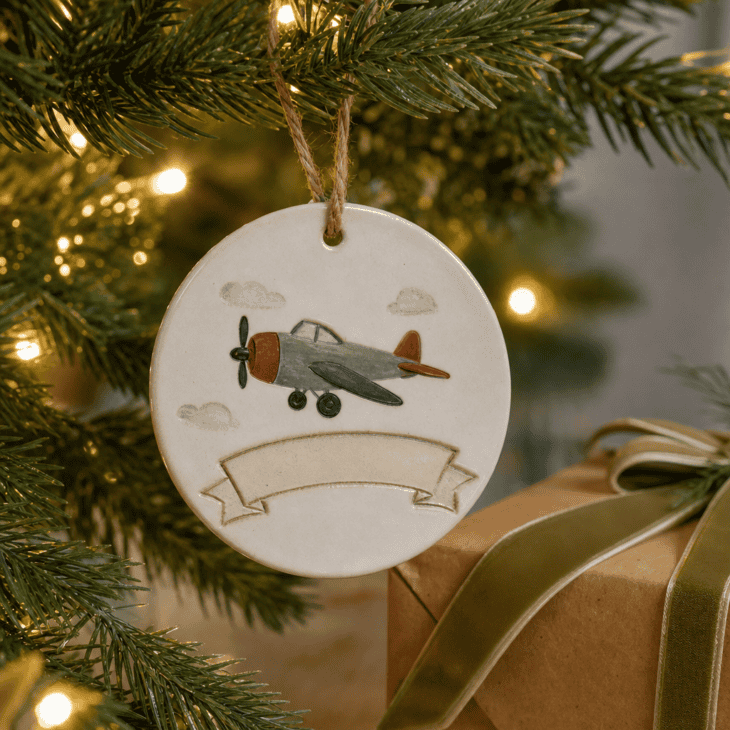 A ceramic ornament with a banner space ready for a name and date.