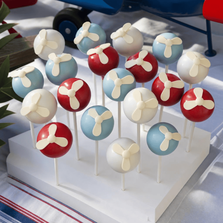 A three-blade chocolate detail gives round cake pops a propeller theme.