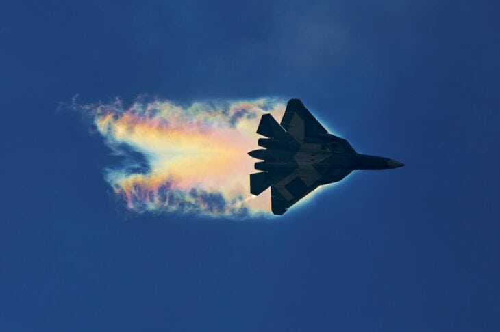 Russian Su-57 fighter in a high-G turn with a vapor cloud forming around the airframe