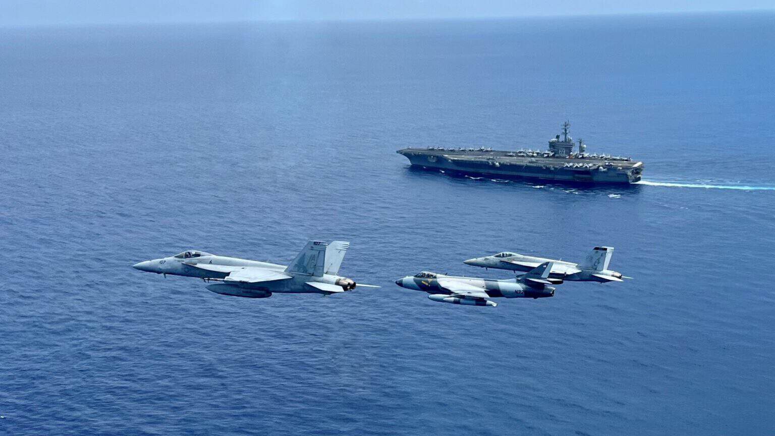 FA-18E Super Hornets and a ATAC Hawker Hunter fly over the Atlantic Ocean near USS Dwight D. Eisenhower (CVN-69), 14 July 2023-16x9