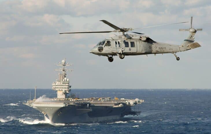 MH-60S Seahawk assigned to the Chargers of Helicopter Combat Support Squadron Two Six (HSC-26) flies towards USS Theodore Roosevelt (CVN 71)